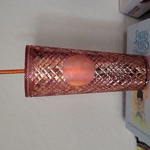 Orange starbucks cup with diamond pattern on cup.